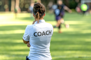 A coach looking at her athletes compete